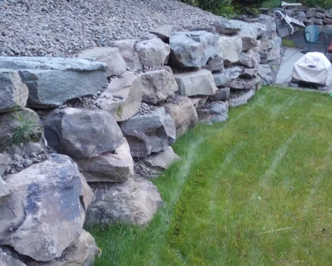 Finished stone retaining wall built on a residential lot