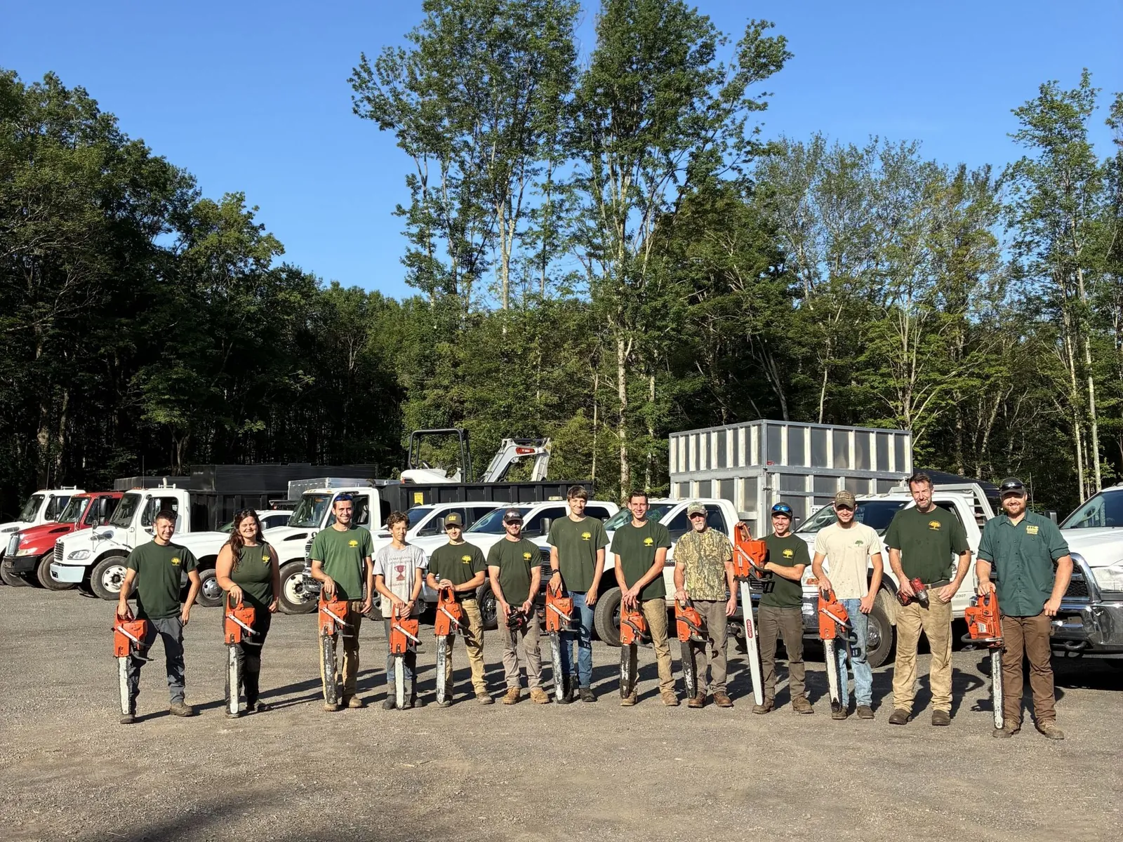 Freeman the Treeman crew posing with chainsaws and equipment